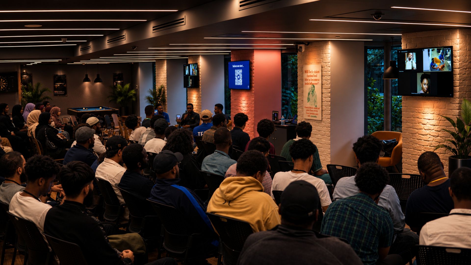 Engineers seated in a modern event space, listening to a panel talk